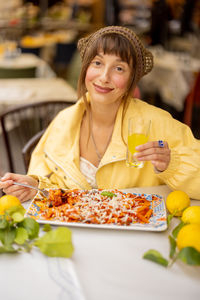 Portrait of young woman having food