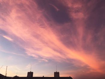 Low angle view of building against dramatic sky