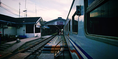 Train at railroad station against sky