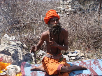 Midsection of man sitting outdoors