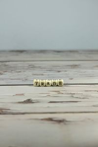 Close-up of coins on table against sea