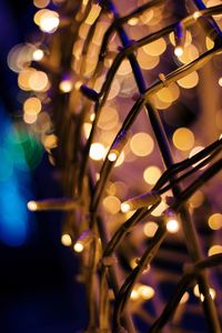 Close-up of illuminated electric lights on ceiling