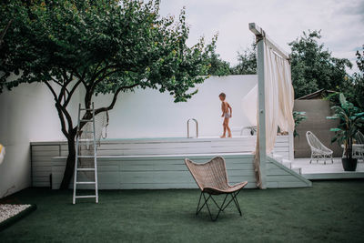 Side view of young woman relaxing in swimming pool