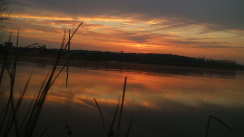 Scenic view of lake against sky during sunset