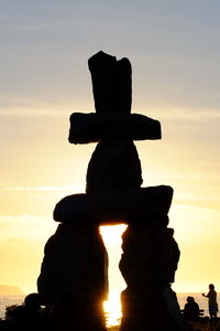 Low angle view of silhouette statue against sky during sunset