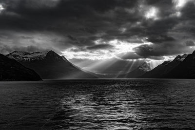 Scenic view of sea and mountains against sky