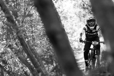 Low section of person riding bicycle on tree