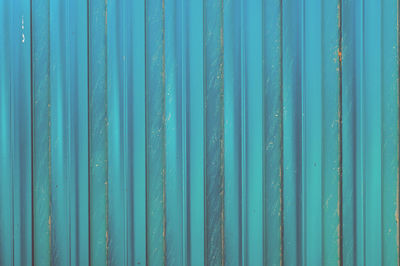 Metal turquoise rusty ribbed fence, texture, copy space
