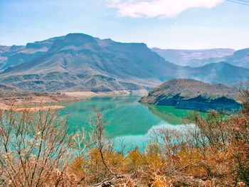 Scenic view of lake against cloudy sky