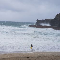 Man standing on beach against sky