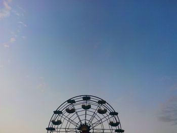 Low angle view of ferris wheel against sky