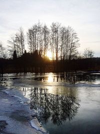 Scenic view of frozen lake against sky during sunset