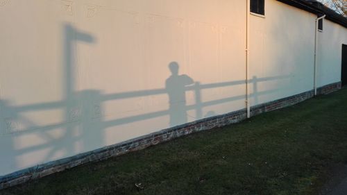 Man with umbrella standing on grass