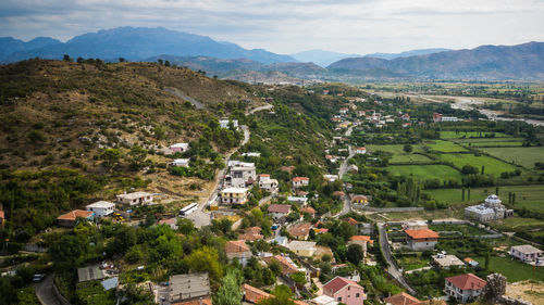 Town and landscape against sky