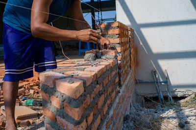 Closeup texture and background of orange bricklayers installed by worker at the construction site