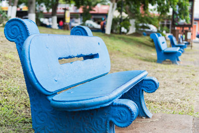 Close-up of empty bench in park