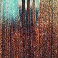 High angle view of fork on wooden table
