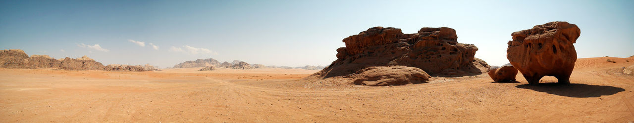 Panoramic view of rock formations in desert against sky