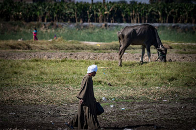 Farmer walking on field