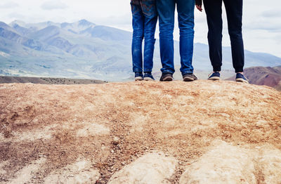 Low section of people standing on land