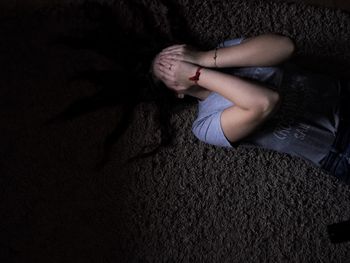 Portrait of young woman over black background