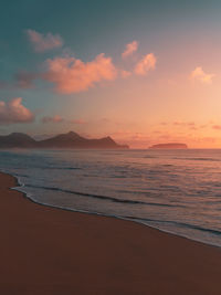 Scenic view of beach against sky during sunset