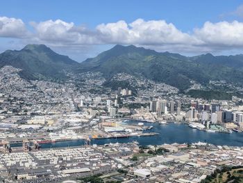 High angle view of townscape by mountains against sky