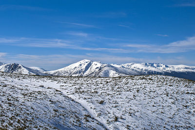 Scenic view of snowcapped mountains against sky