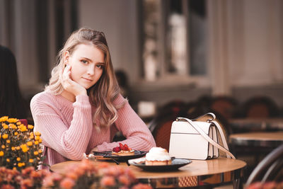 Portrait of teenager girl sitting at restaurant