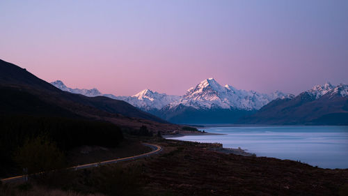 Scenic view of snowcapped mountains against sky during sunset