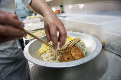 Midsection of man preparing food in kitchen