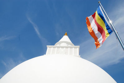 Low angle view of flag on building against sky