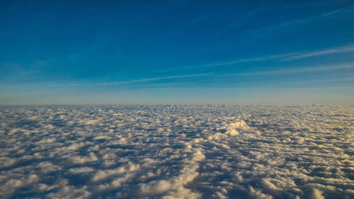 Aerial view of landscape against blue sky