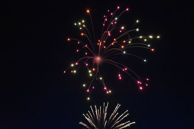 Low angle view of firework display at night