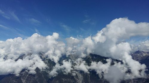 Scenic view of mountains against cloudy sky