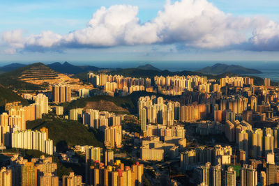 Aerial view of buildings in city against sky