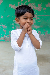 Portrait of cute boy standing outdoors