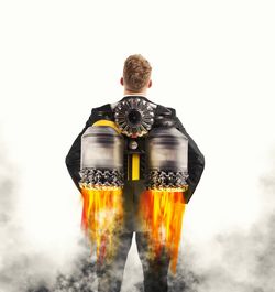 Rear view of man standing against white background