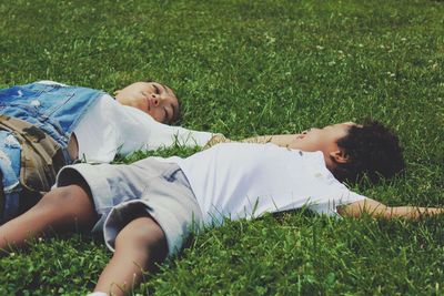 Low section of girl lying on grass