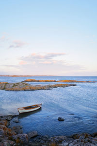 Traditional cutter lying in the water between the skarries in western sweden