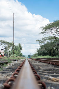 Surface level of railroad tracks against sky