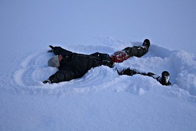 Mature woman making snow angel