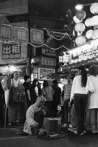 People on street in city at night