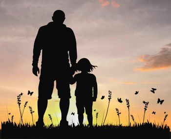 Silhouette people on field against sky during sunset