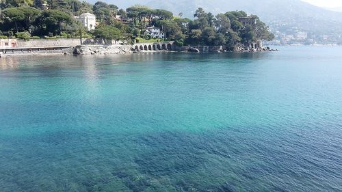 Swimming pool by sea against sky