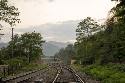 Railway tracks on mountain against sky