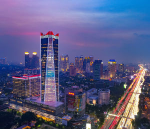 High angle view of illuminated buildings against sky at night