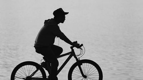 Side view of man riding bicycle