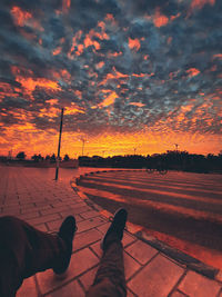 Low section of man against orange sky