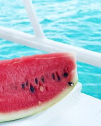 Close-up of strawberry in swimming pool against sea